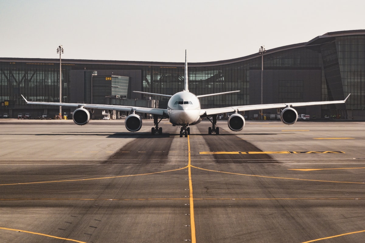 Wide-body aircraft taxiing in front of a terminal